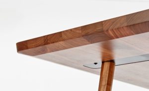 Marlon Dining Table in simple modern shape made of wood with detail about connection of leg and plate