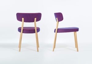 Marlon Dining Chair with wide back and seat in modern dynamic shape covered with blue and pink fabric and light wooden legs