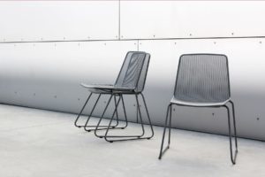 Haley Chairs with base in bent steel tube and seat and backrest in steel mesh in dark colors. One free standing chair and two stacked chairs.
