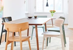 Marlon Solid Wood Chairs with wide back in modern dynamic shape in different colours around a wooden table