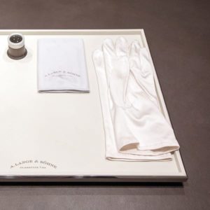 Watchtray tablet in rectangular shape in light beige with gloves, cleaning cloth and watchmaker loupe