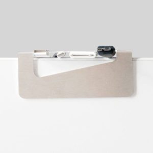 Cable Clip made of bent and punched metal holds various cables on white desk