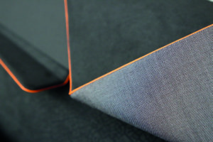 Car Interior Concept folded door panel covered with dark fabric and orange edge accents