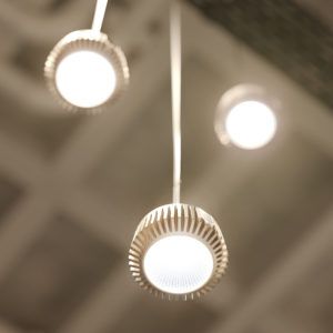 Three Pohlcon SystemPlus pendant luminaires with cooling fins hang from the ceiling