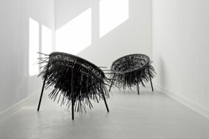 Two Oricio lounger made of interwoven cable ties with wild spiky structure in light room