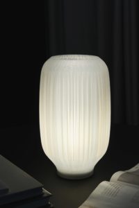 Lucia table lamp with organically folded lampshade on dark table