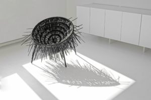 Oricio chair made of interwoven zip ties with wild spiky texture in bright room with nice shadow